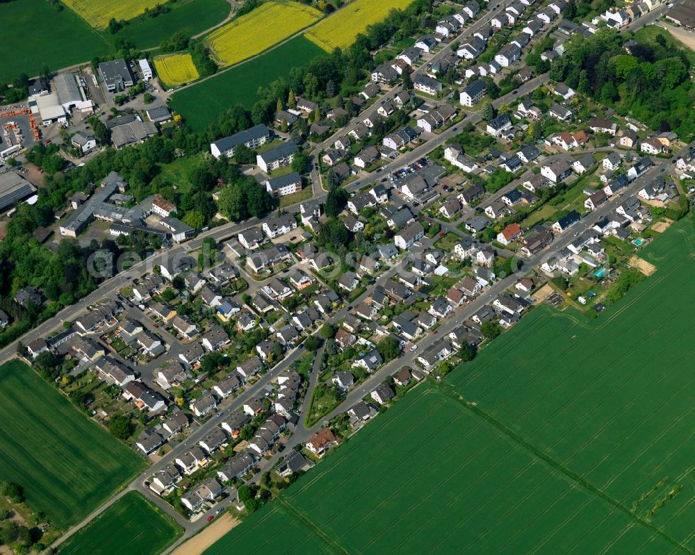 Neuwied from above - View of the Oberbieber part of the town of Neuwied in the state of Rhineland-Palatinate. The town is located in the county district of Mayen-Koblenz on the right riverbank of the river Rhine. The town is an official tourist resort and is an important historic industrial site. Oberbieber is located in its North, surrounded by meadows and rapeseed fields in the foothills of the Westerwald forest. The historic roads Limesstrasse, Raiffeisenstrasse and the hiking track Rheinsteig meet here