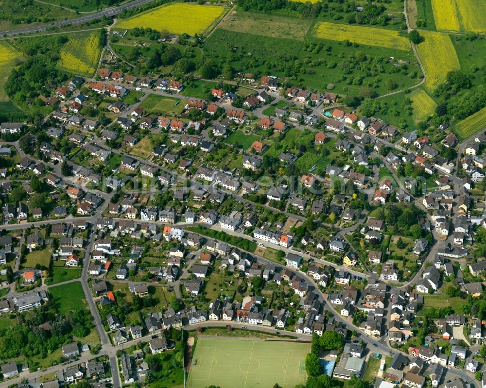 Neuwied from above - View of the Oberbieber part of the town of Neuwied in the state of Rhineland-Palatinate. The town is located in the county district of Mayen-Koblenz on the right riverbank of the river Rhine. The town is an official tourist resort and is an important historic industrial site. Oberbieber is located in its North, surrounded by meadows and rapeseed fields in the foothills of the Westerwald forest. The historic roads Limesstrasse, Raiffeisenstrasse and the hiking track Rheinsteig meet here