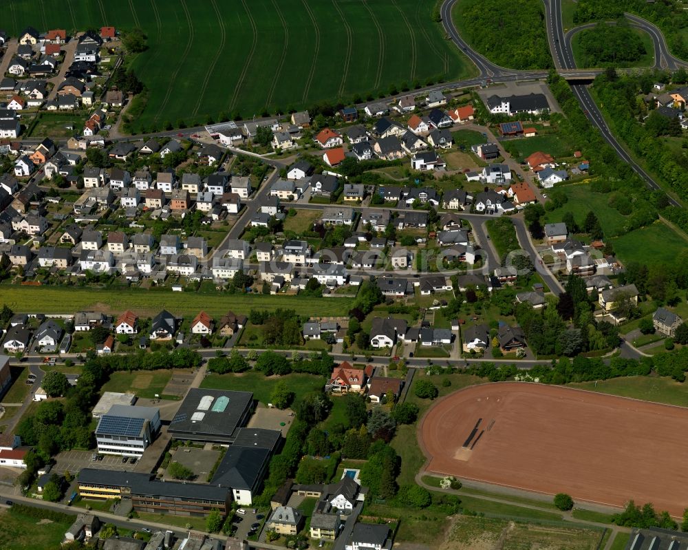 Aerial image Mendig - View of the East of the Obermendig part of Mendig in the state Rhineland-Palatinate. The town is located in the county district of Mayen-Koblenz in the Eastern Eifel region. It is known as a town of breweries and lava cellars - from volcanic origin. Mendig consists of two parts. A high school is located in the East of Obermending which includes a large sports area and facilities