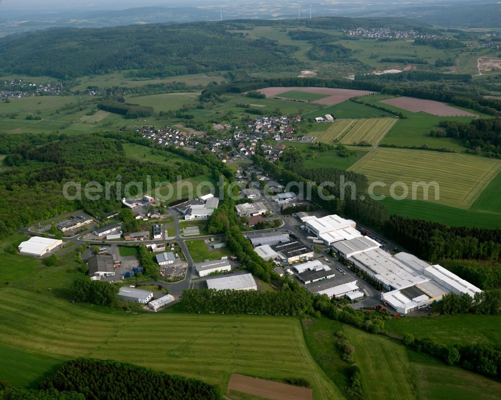 Westerburg from above - View of the Sainscheid part of the town of Westerburg in the state of Rhineland-Palatinate. The town is located in the county district of Westerwaldkreis, is an official tourist resort and widely known for the castle hill and its castle. Sainscheid is located in the South of the town area, surrounded by fields, meadows and forest. An industrial site is located in the North of Sainscheid with halls, factories and white roofs