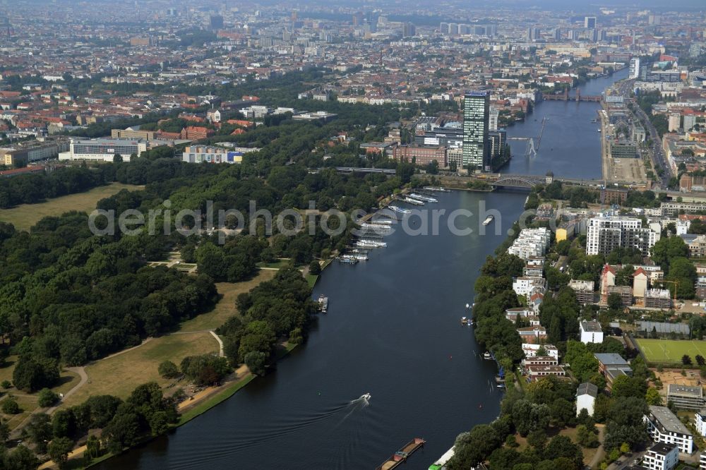 Berlin from the bird's eye view: View of the Treptow and Friedrichshain-Kreuzberg parts along the river Spree in Berlin in Germany. View from the East towards Mitte. Several landmarks such as the Molecule Man and the Oberbaumbruecke Bridge are visible