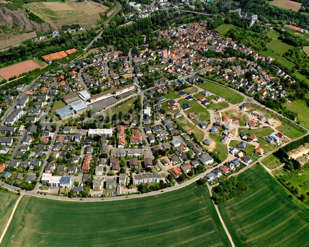 Bad Münster am Stein-Ebernburg from the bird's eye view: View of the Western part of Bad Muenster am Stein-Ebernburg part of Bad Kreuznach in the state of Rhineland-Palatinate. Bad Muenster is a spa resort and has been made a district of Bad Kreuznach in 2014. It is located in the valley of the river Nahe, surrounded by forest which are landmarks and important tourist sites, forest and vineyards. The West includes several sports grounds and pitches on the Nahe riverbank