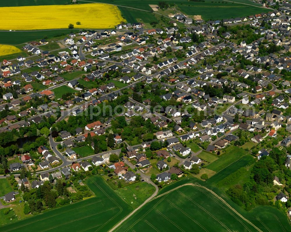 Aerial photograph Mendig - View of the West of the Obermendig part of Mendig in the state Rhineland-Palatinate. The town is located in the county district of Mayen-Koblenz in the Eastern Eifel region. It is known as a town of breweries and lava cellars - from volcanic origin. Mendig consists of two parts. The residential areas on the edge of the town are surrounded by rapeseed fields