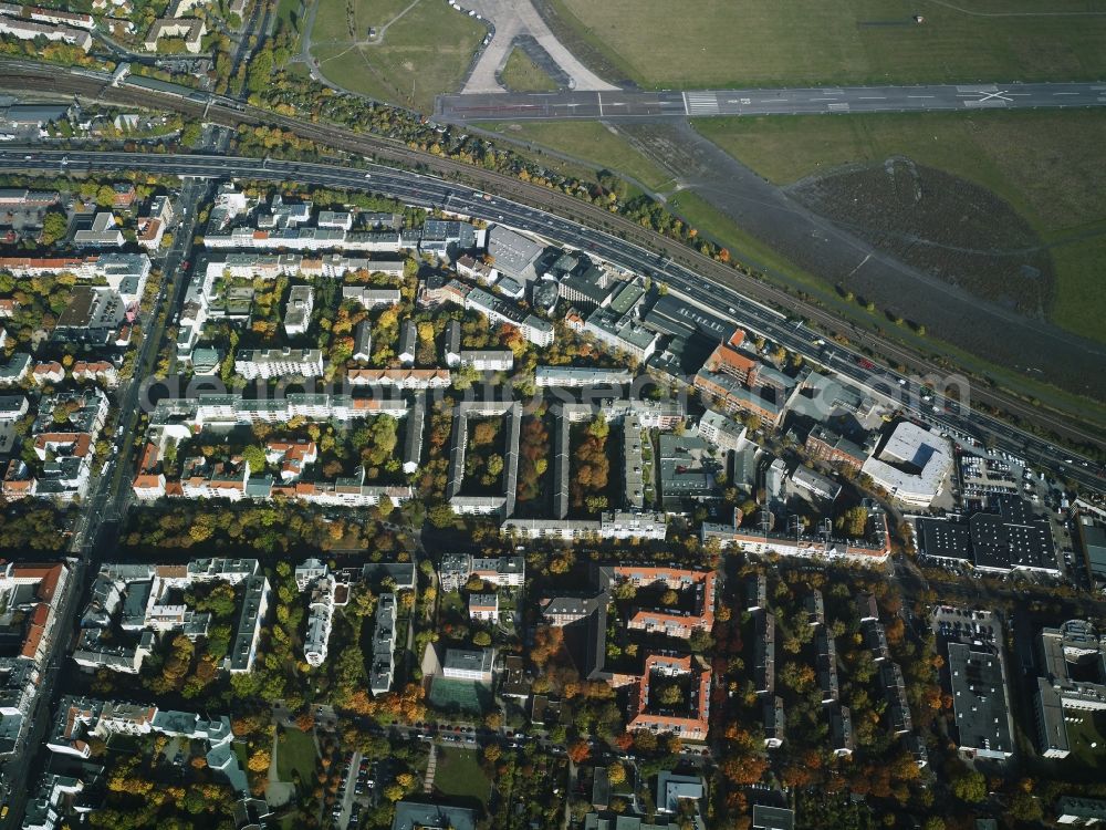 Berlin from above - View of the residential area in the South of the city motorway A100 and Tempelhofer Feld in the district of Tempelhof-Schoenebeg in Berlin in Germany. The residential estates are located amidst green areas and company compounds on the motorway. The area of the former Airport Tempelhof with its Southern runway is located in its North