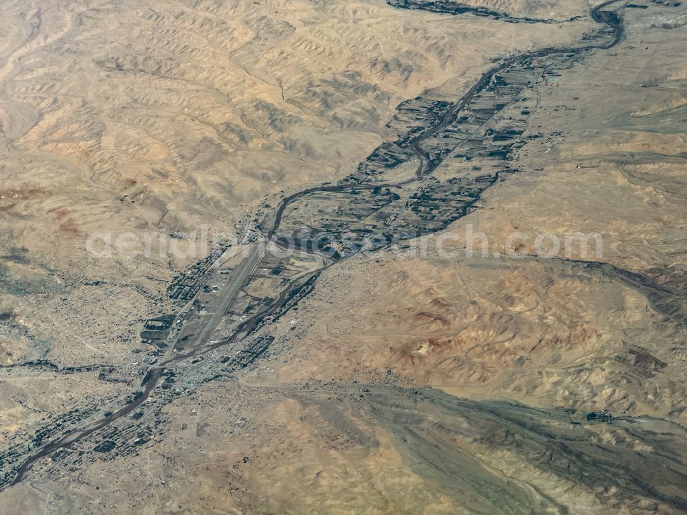 Chaghcharan from the bird's eye view: City center in the downtown area on the banks of river course Hari River on street Airport Road in Chaghcharan in Ghor, Afghanistan