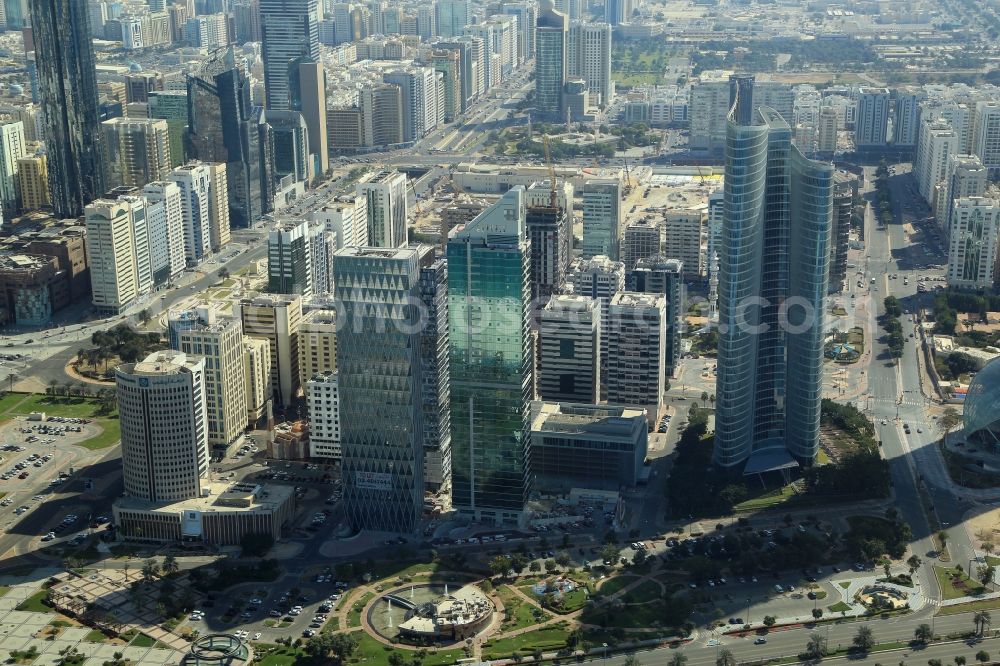 Abu Dhabi from the bird's eye view: City center with the skyline in the downtown area at Corniche Road, Urban Park and Investment Authority Tower in Abu Dhabi in United Arab Emirates