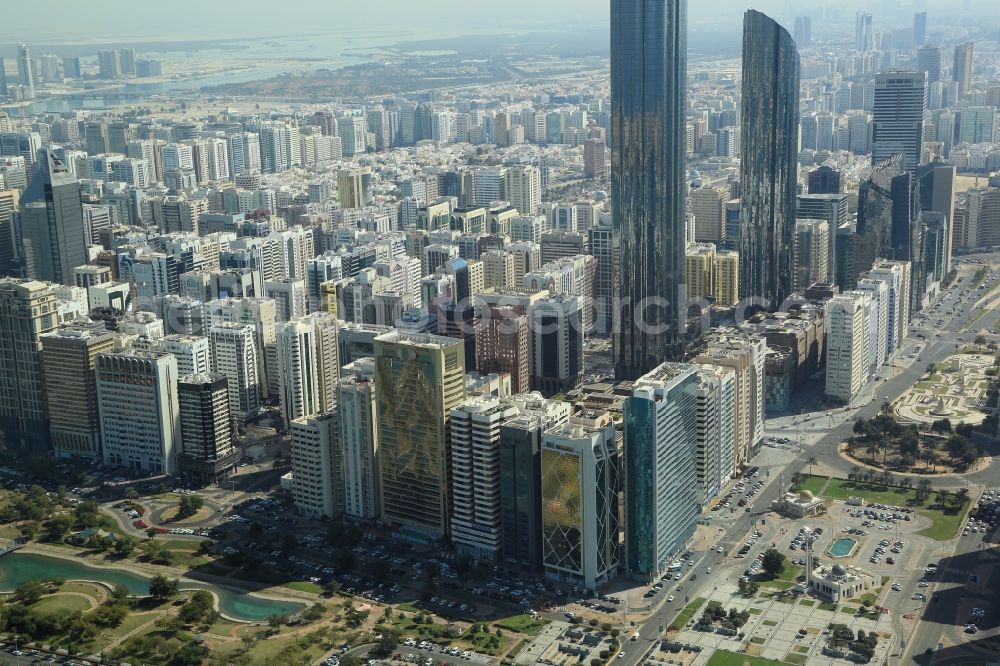 Aerial image Abu Dhabi - City center with the skyline in the downtown area at Corniche Road and skyscraper Burj Mohammed Bin Rashid in the area of the World Trade Center in Abu Dhabi in United Arab Emirates. Der Mohammed Bin Rashid Tower ist derzeit der hoechste Wolkenkratzer in Abu Dhabi und hebt sich von den umliegenden Hochhaeusern deutlich ab