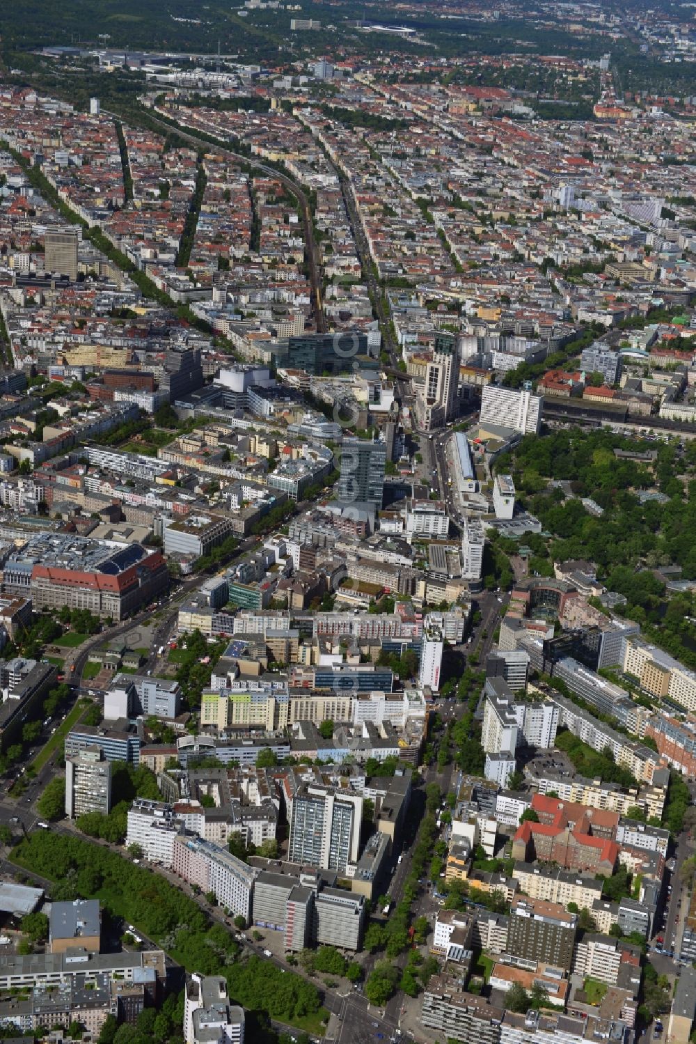 Aerial photograph Berlin - From Kleiststrasse on the Wittenberg Platz to Tauentziehnstrasse, then continue on the Breitscheidplatz and the Budapest Street, the trendy shopping district of the City-West pulls in the districts of Schoeneberg and Charlottenburg in Berlin. On the Wittenberg Platz is the KaDeWe department store. The Breitscheidplatz is characterized by the Memorial Church, Europe Zenter, the high-rise Zoofenster with the luxury Waldorf Astoria Hotel and the newly renovated Bikini house. This city counts with the large number of attractions to the hottest destinations in the city. Good catch me is the hotspot by train at the Zoologischer Garten railway station or the subway, which has a distinctive station building on the Wittenberg Platz. In the picture, parts of the Berlin Zoological Garden can be seen