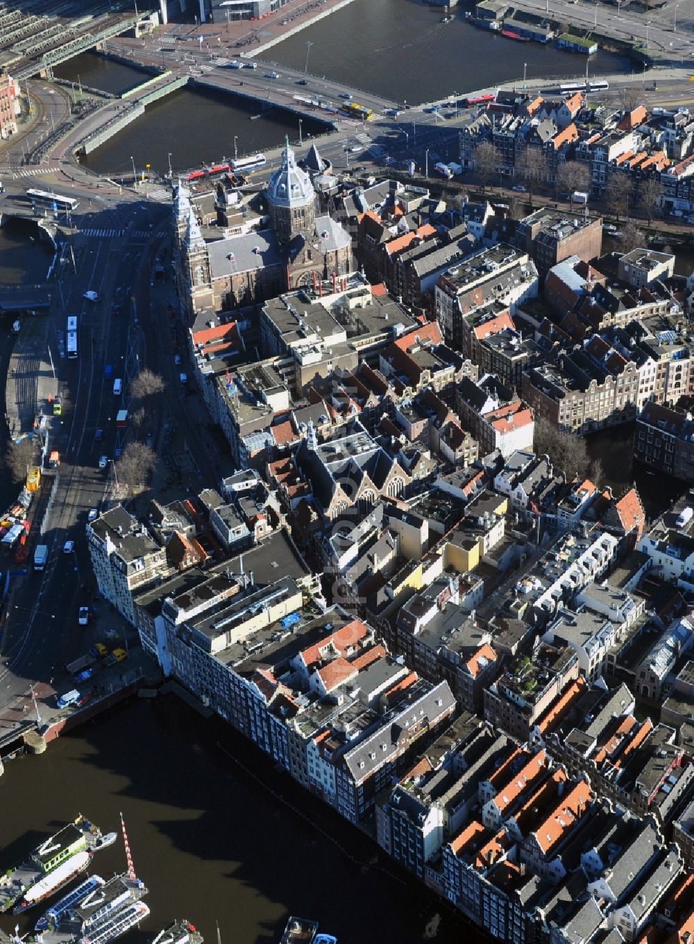 Aerial image Amsterdam - City center with residential areas and canals channels at the Church of St. Nicholas in the center of Amsterdam in the Netherlands