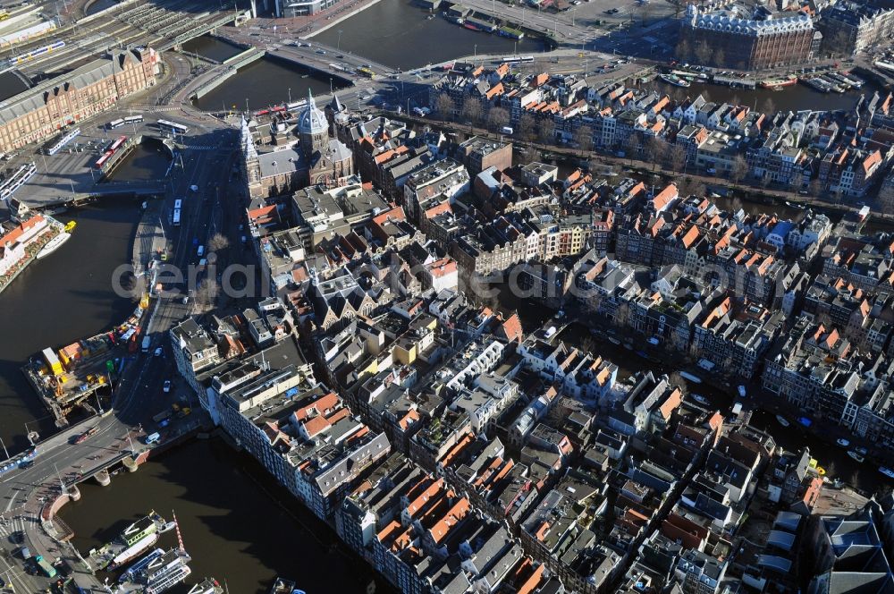 Aerial photograph Amsterdam - City center with residential areas and canals channels at the Church of St. Nicholas in the center of Amsterdam in the Netherlands