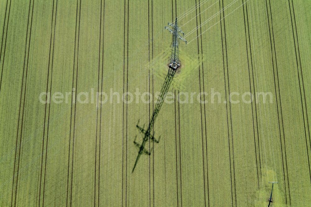 Poing from above - Steel mast of the current track an overland power line on a winter cereal field in Poing-Grub in Upper Bavaria in Bavaria