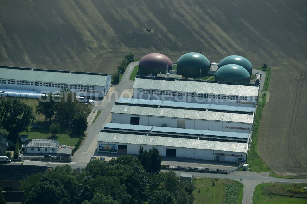 Ochelmitz from above - Stables of an agricultural business with biogas plant in the South of Ochelmitz in the state of Saxony. The village is characterised by agricultural estates and farms and is surrounded by fields. The colourful domes of the digester are visible