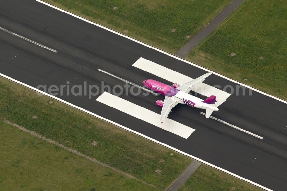 Aerial photograph Dortmund - Start of an Airbus A320 on the runway of the airport Dortmund in North Rhine-Westphalia Wickede. The Wizz Air is a 2004 founded Ukrainian air carriers