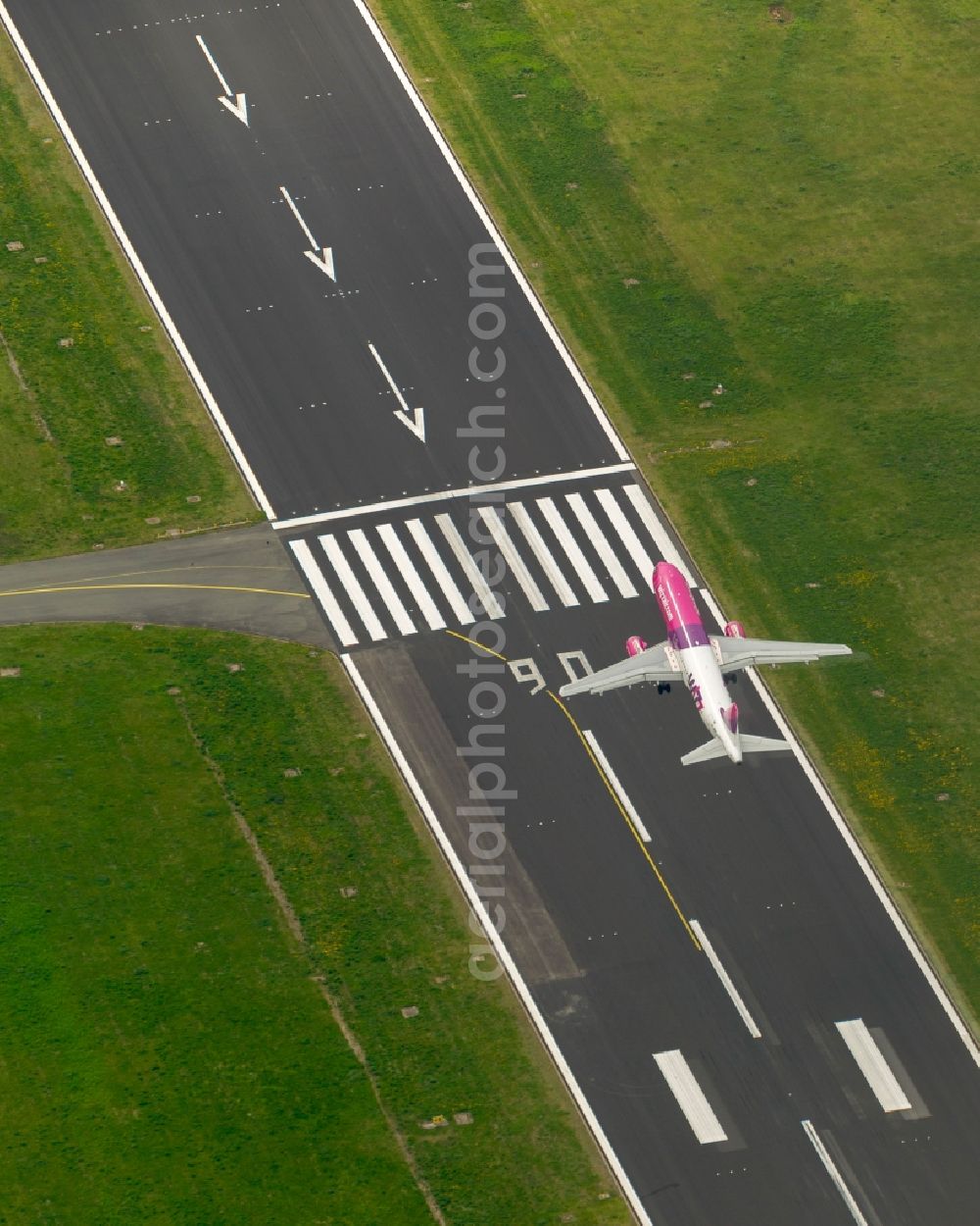 Aerial image Dortmund - Start of an Airbus A320 on the runway of the airport Dortmund in North Rhine-Westphalia Wickede. The Wizz Air is a 2004 founded Ukrainian air carriers