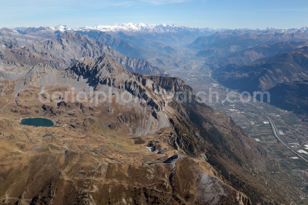 Aerial image Fully - Mountainous landscape at the Lake Fully in Fully in the canton Valais, Switzerland. Looking over the Grand Chavalard mountain eastbound into the Rhone valley,