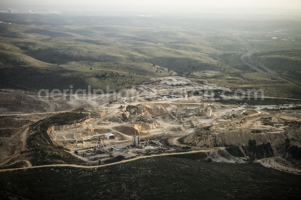 Aerial photograph Ramla - Stone quarry pit close to the Moshav Yad Rambam in the Central District of Israel. Nearby is the district capital of Ramla. A Moshav is a settlement and particular type of cooperative agricultural community. The quarry lies between the motorways Route 1 and Route 6 approximately 35 km south east of Tel Aviv