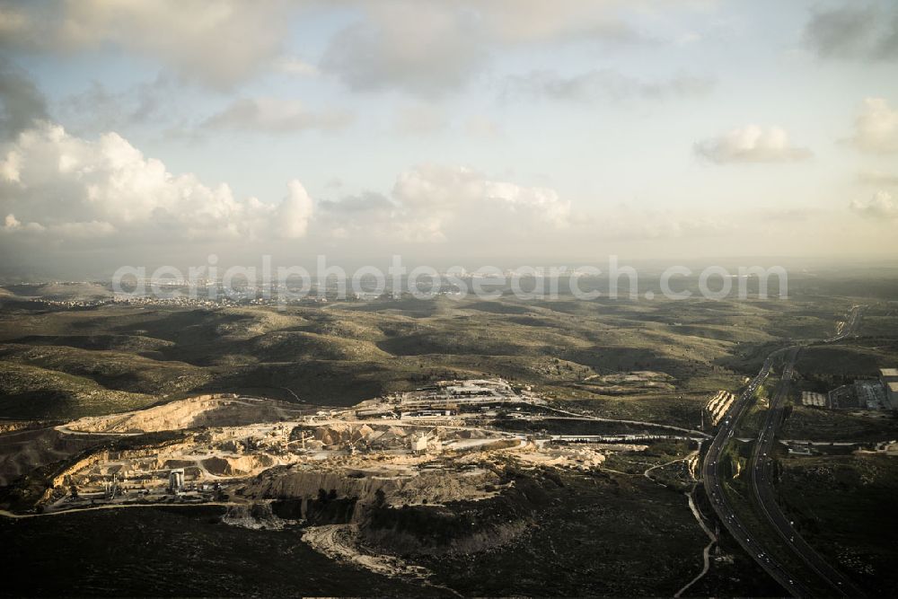 Ramla from above - Stone quarry pit close to the Moshav Yad Rambam in the Central District of Israel. Nearby is the district capital of Ramla. A Moshav is a settlement and particular type of cooperative agricultural community. The quarry lies between the motorways Route 1 and Route 6 approximately 35 km south east of Tel Aviv