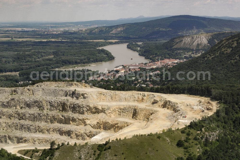 Aerial image Bad Deutsch-Altenburg - Quarry Steinbruch Hollitzer of Rohrdorfer Group in Bad Deutsch-Altenburg in Lower Austria, Austria. The Stone quarry is located on Pfaffenberg mountain, near the riverbank of the Danube. View from the South