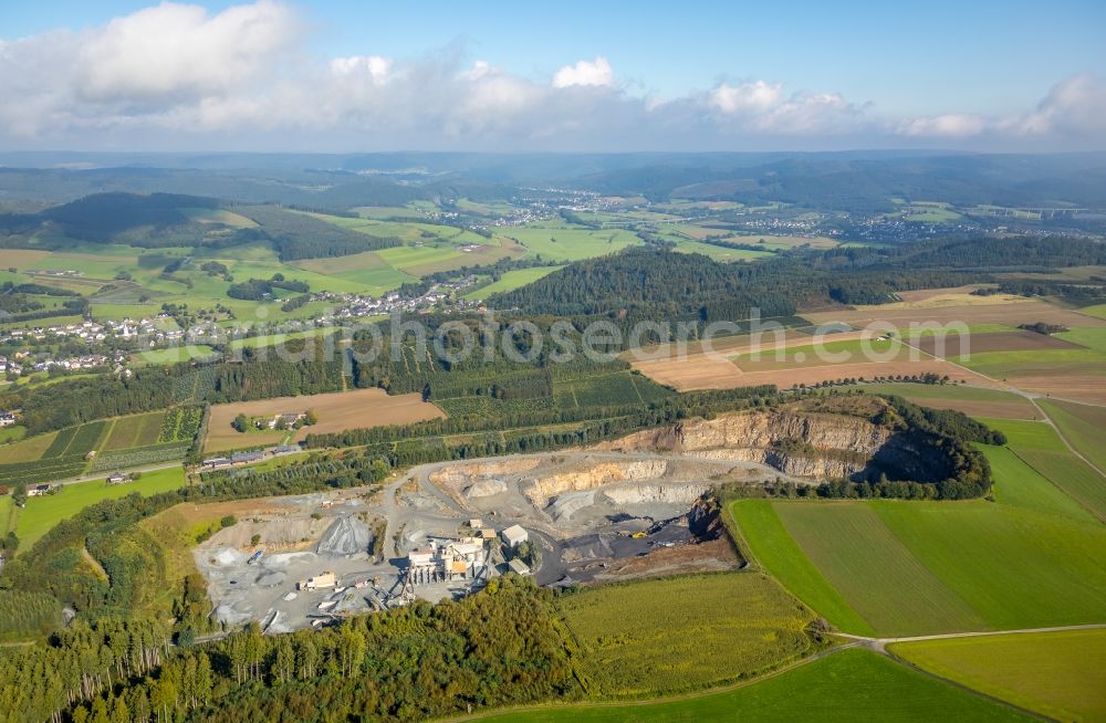 Meschede from the bird's eye view: Quarry to the mining and handling of greywacke carbonate and hard stone - diabase from the Mineral Baustoff GmbH Werk BERGE and the Westdeutsche Grauwacke-Union GmbH Zur Winnschla in Meschede in North Rhine-Westphalia, Germany