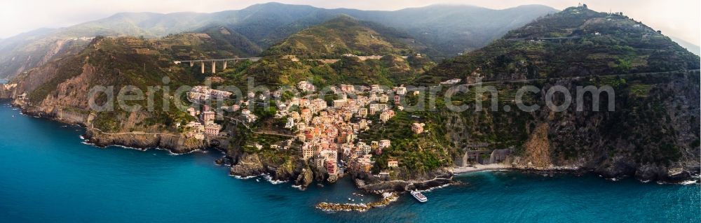 Riomaggiore from above - Stony beach landscape on the coast the Mediterranean sea in Riomaggiore in Liguria, Italy