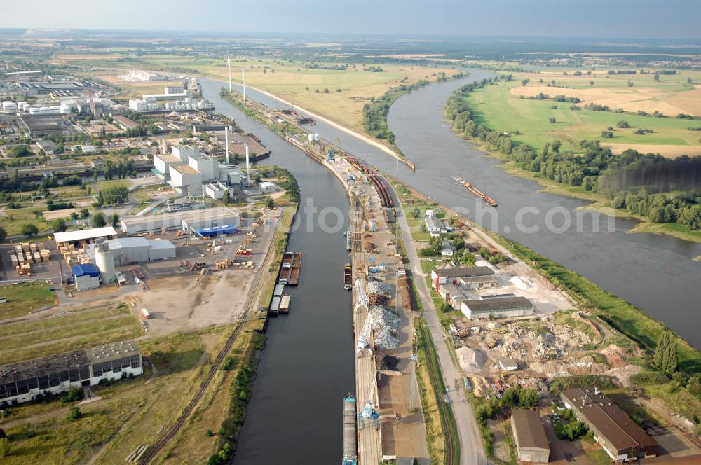 Aerial photograph Magdeburg - Blick auf die Steinkopfinsel im Hafen Magdeburg an der Elbe. Umflossen wird die Steinkopfinsel im Osten von der Elbe und dem Abstiegskanal Rothensee, sowie im Westen vom Zweigkanal Magdeburg. Die Insel ist ca. 2,5 km lang und ca. 0,3 km breit (an der stärksten Stelle). Der Binnenhafen ist in vier Güterumschlagplätze eingeteilt, der Handelshafen, Industriehafen, Kanalhafen und der Hanseshafen. Das Gebiet verteilt sich über die Stadtteile Alte-Neustadt, Industriehafen und Gewerbegebiet Nord. Jedoch hat der Handelshafen für die Schiffahrt heute keine Bedeutung mehr, dieser Bereich wird stetig zum Wissenschaftsstandort umgebaut. Kontakt: Magdeburger Hafen GmbH, Saalestraße 20, 39126 Magdeburg, Tel. +49(0)391 5939-0, Fax +49(0)391 5616648, email: Logistik@magdeburg-hafen.de