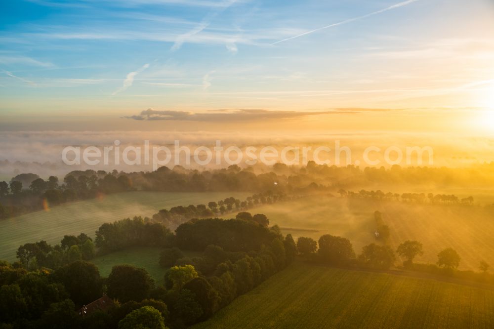 Hohenlockstedt from the bird's eye view: Weather related fog banks and cloud layer in Sonnenaufgang in Hohenlockstedt in the state Schleswig-Holstein, Germany