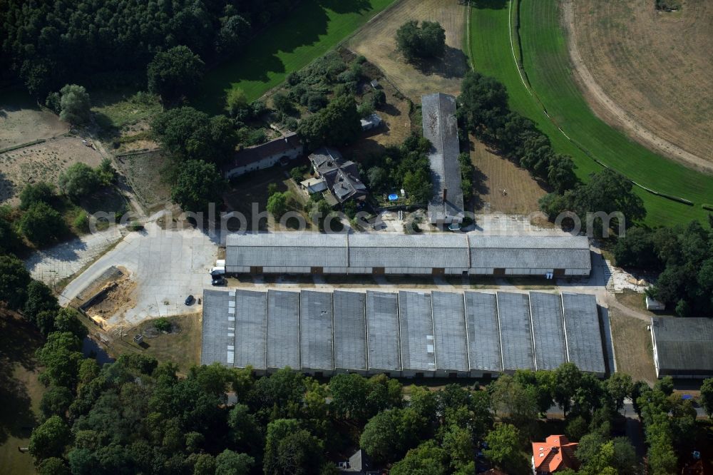 Hoppegarten from above - Building of stables and outbuildings of the horse race track in Hoppegarten in the state of Brandenburg. The buildings and storage halls are located on the Northern end of the historic race track