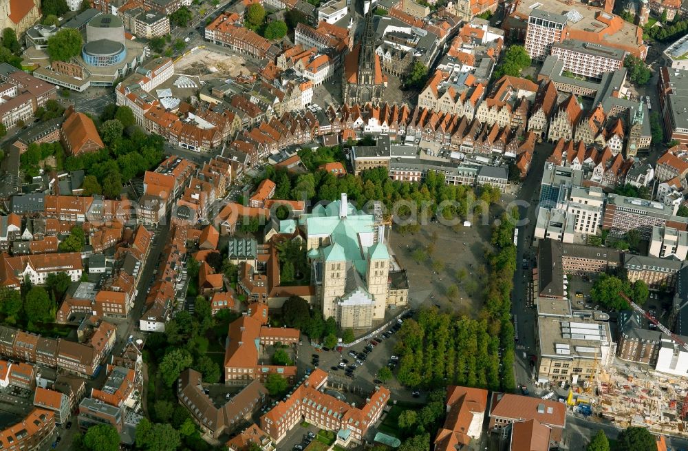 Münster from above - Muenster Cathedral in downtown Muenster in the state of North Rhine-Westphalia. The cathedral is located on Dom Square on a hill called Horsteberg, surrounded by historic residential and business buildings which used to form the old Domburg (Cathedral Castle). The church is one of the landmarks of the city and is run by the Domkapitel. The distinct green roof and the two twin towers are wellknown features of the church building