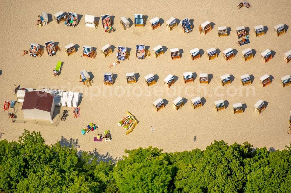 Aerial image Kolobrzeg - Kolberg - Beach chair on the sandy beach ranks in the coastal area the Baltic Sea in Kolberg in West Pomerania, Poland