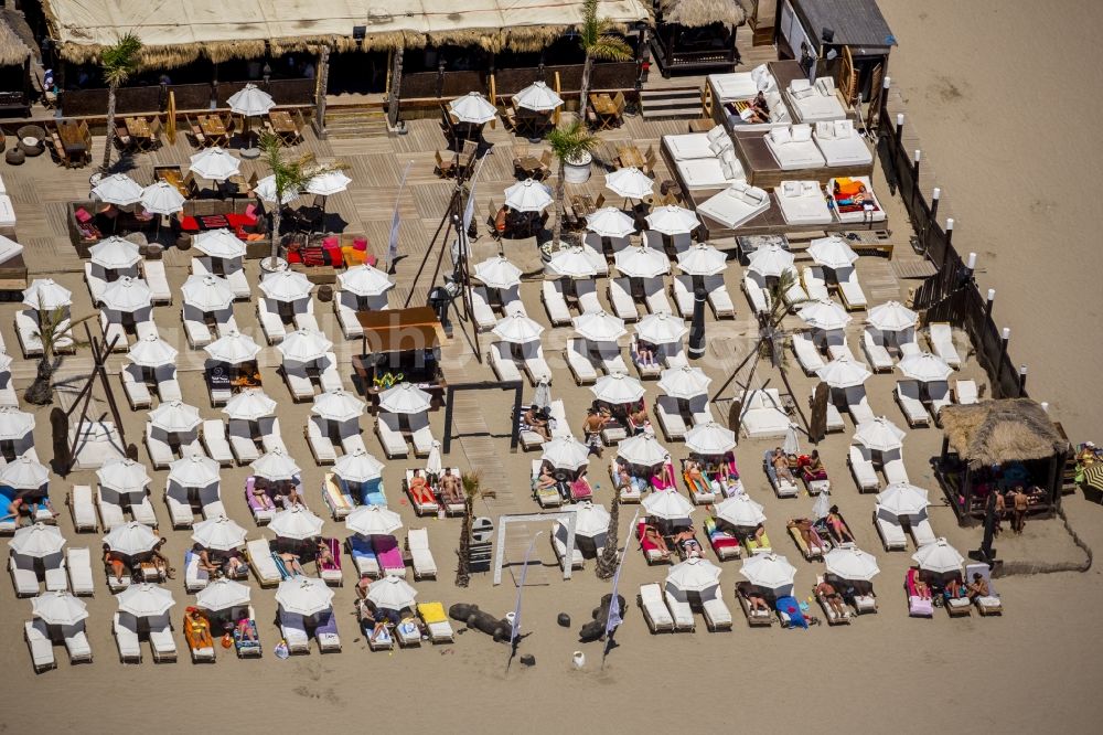 Agde from the bird's eye view: Beach lying places and umbrella on the sandy beach landscape of Agde on the Mediterranean coast in France. Use not permitted in personal rights affecting Zoom cutouts!