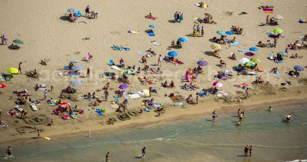 La Grande-Motte from the bird's eye view: Beach lying places and umbrella on the sandy beach landscape of La Grande-Motte in France. Use not permitted in personal rights affecting Zoom cutouts!