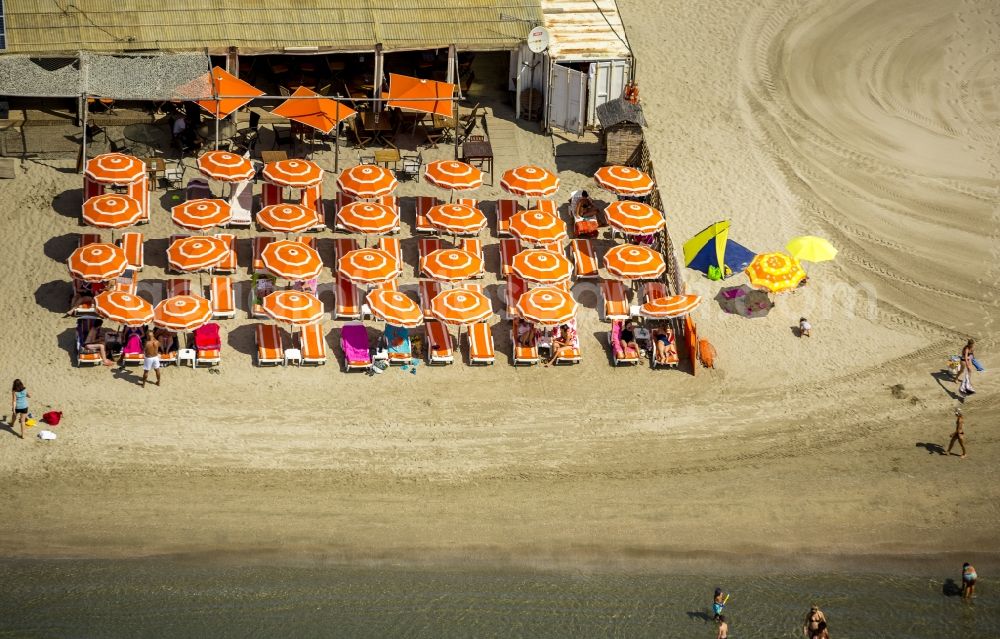 Aerial image La Grande-Motte - Beach lying places and umbrella on the sandy beach landscape of La Grande-Motte on the Mediterranean coast in France. Use not permitted in personal rights affecting Zoom cutouts!