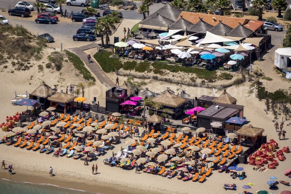 Marseillan from above - Nudism on the beach lying places in the landscape with a beach umbrella on the sandy beach of Marseillan on the Mediterranean coast in France. CAUTION Use not permitted in personal rights affecting Zoom cutouts!