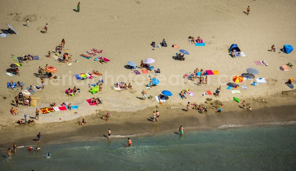 Aerial image Mauguio - Beach lying places and umbrella on the sandy beach landscape of Mauguio on the Mediterranean coast of the province of Languedoc-Roussillon in France