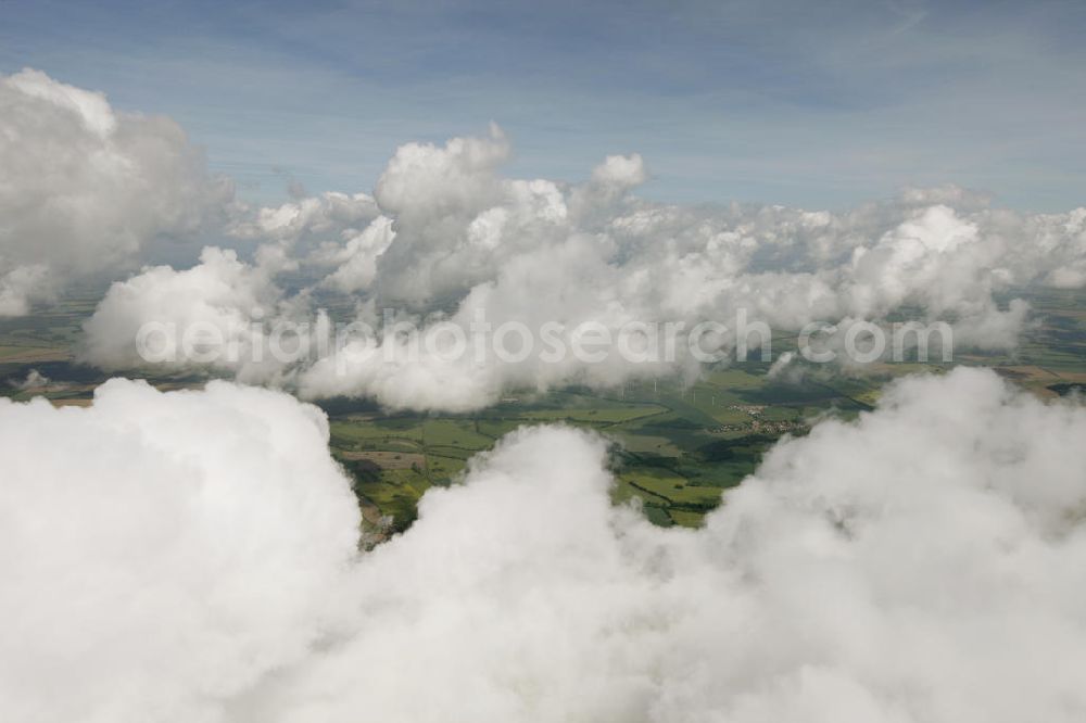 Aerial photograph Heiligengrabe - Blick auf Strato- und Kumuluswolkenfelder über landwirtschaftlichen Feldern der Ostprignitz im Umfeld von Heiligengrabe. Besonders in den Vormittagsstunden neigt frühsommerliches Wetter oft zu Quellwolkenbildung mit Niederschlag. View of Strato-cumulus clouds over farm fields near Heiligengrabe.