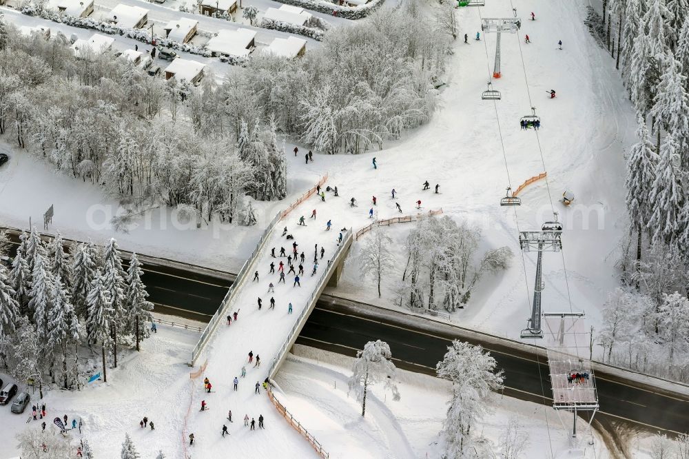 Aerial image Winterberg - Winter - view of the snow-line of descent with mountain ski station, ski and sailing in Winterberg in North Rhine-Westphalia NRW