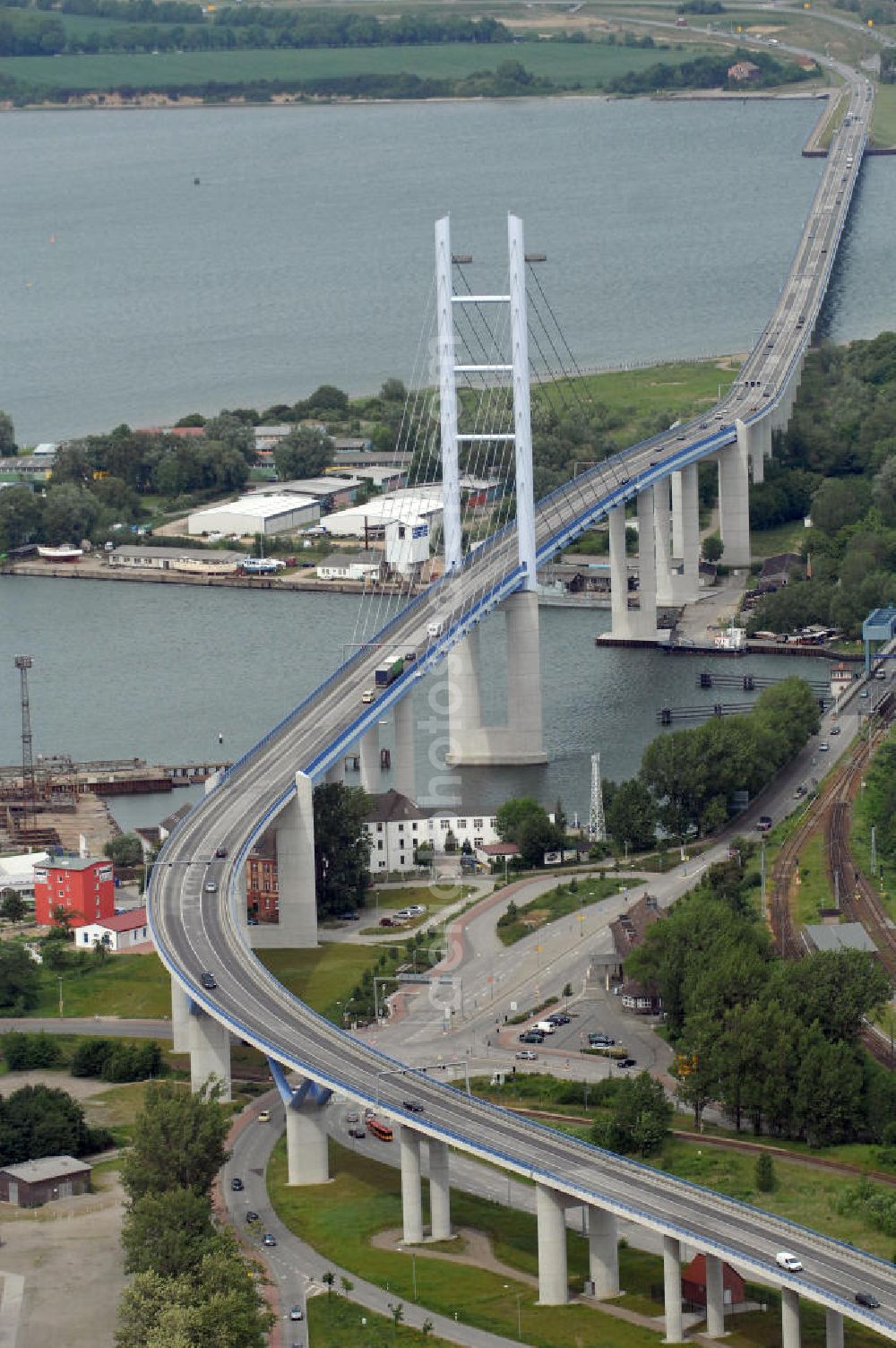 Aerial photograph Stralsund - Mit dem Begriff Strelasundquerung werden die beiden Brückenverbindungen der Insel Rügen über den Strelasund zum vorpommerschen Festland bei Stralsund, die Rügenbrücke und der Rügendamm , sowie die regelmäßig betriebenen Fährverbindungen zwischen Stralsund und Altefähr sowie Stahlbrode und Glewitz bezeichnet. Der Rügendamm ist die erste feste Strelasundquerung, über den sowohl die alte Bundesstraße 96, als auch eine eingleisige Eisenbahnstrecke sowie ein kombinierter Fuß- und Radweg führen. Sie wurde 1936/1937 fertiggestellt. Rügenbrücke ist der Name der im Jahr 2007 fertiggestellten dreispurigen Hochbrücke ausschließlich für den Kraftfahrzeugverkehr zwischen der Ortschaft Altefähr auf Rügen und der Hanse- und Weltkulturerbestadt Stralsund im Zuge der als Ortsumgehung ausgebauten Bundesstraße 96. Beide Brücken werden parallel betrieben. (DEGES, MAX BÖGL)