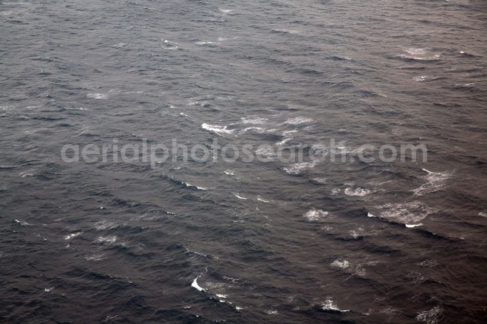 Monaco from above - Waves and spray in stormy seas in the Mediterranean Sea off the coast of St-Jean-Cap-Ferrat peninsula in the district of Monte-Carlo in Monaco. The sea is restless