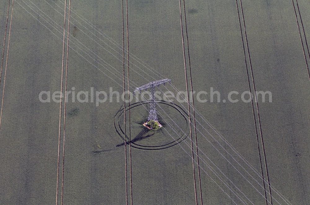 Aerial photograph Erfurt - View on a pylon of a high voltage line standing in a green field near Erfurt in the state of Thuringia. The lane for the tractor are shown in the field