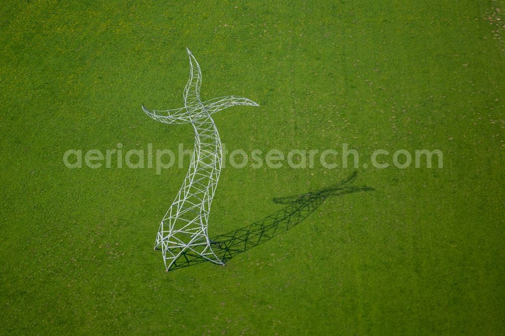 Oberhausen from the bird's eye view: Power tower-construction of a road and Interconnector Steel sculpture sorcerer - dancing electricity pylon in Oberhausen in the state North Rhine-Westphalia