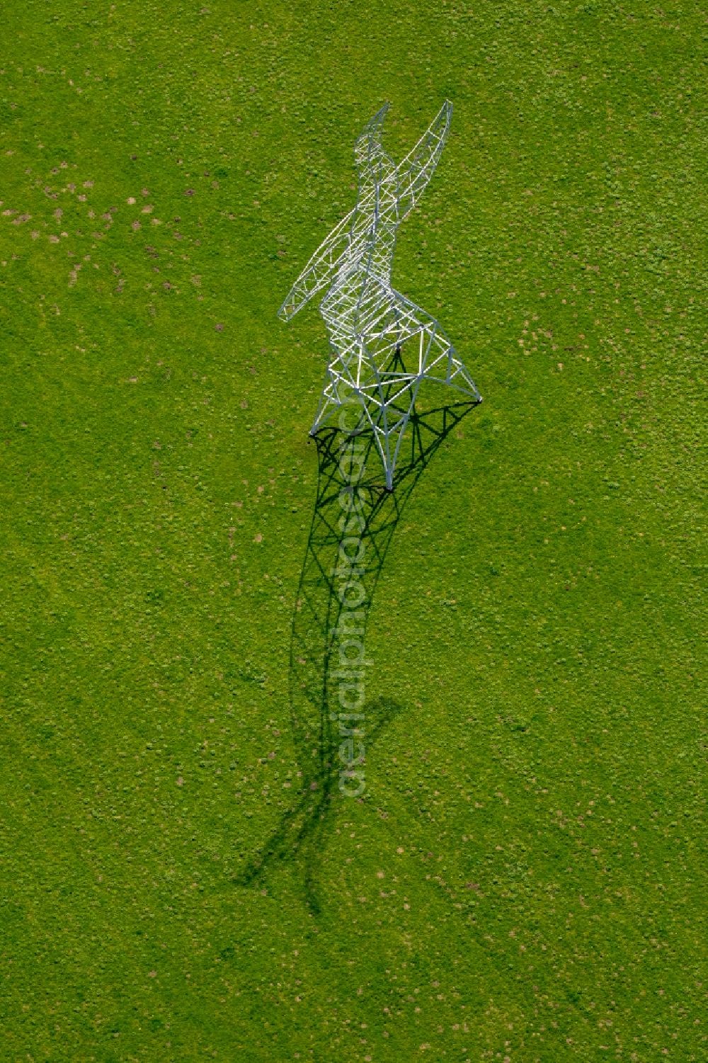 Aerial image Oberhausen - Power tower-construction of a road and Interconnector Steel sculpture sorcerer - dancing electricity pylon in Oberhausen in the state North Rhine-Westphalia