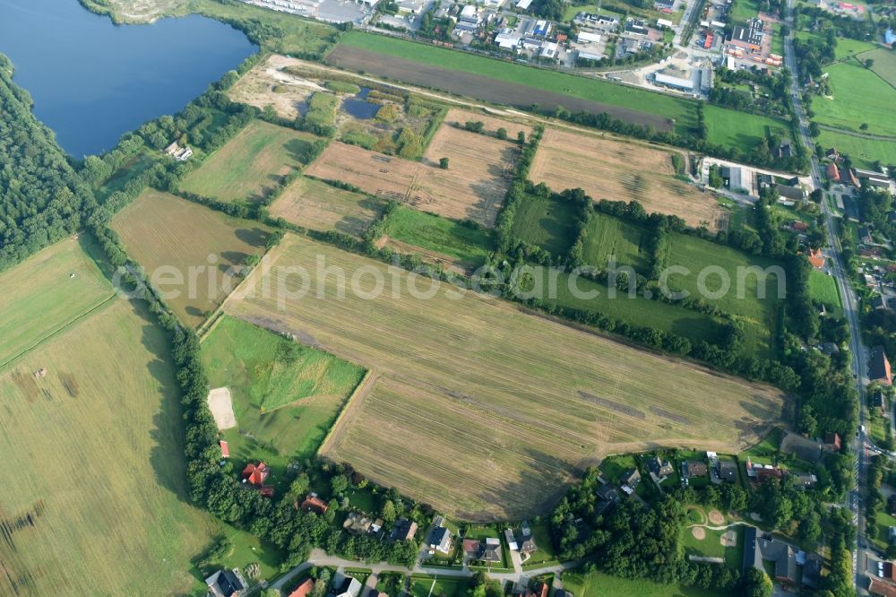 Aurich from the bird's eye view: Structures on agricultural fields near the industrial estate Sandhorst in Aurich in the state Lower Saxony