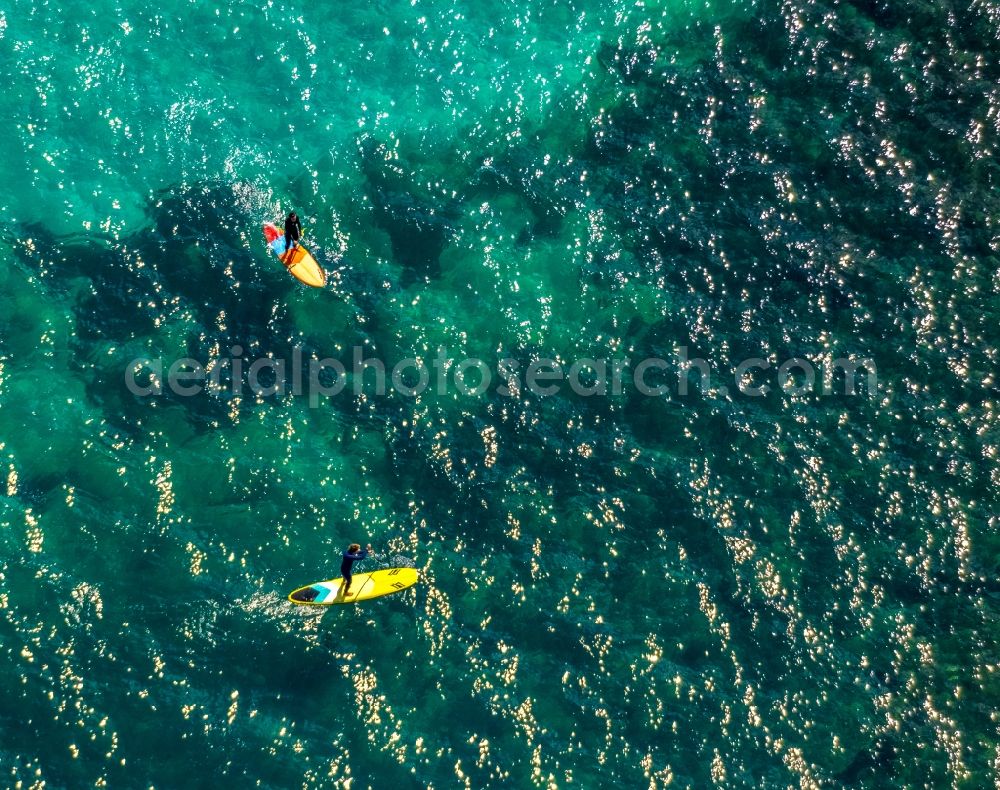 Aerial image Son Real - SUP board sport boat in motion on the water surface in the bay of Alcudia in Son Real in Balearic island of Mallorca, Spain