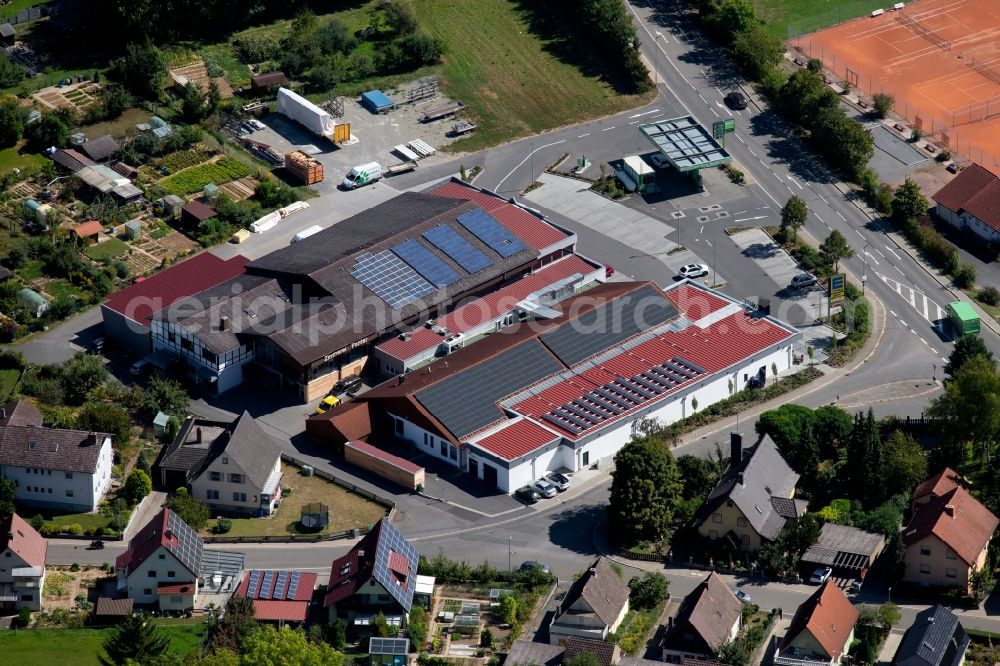 Grünsfeld from the bird's eye view: Store of the Supermarket Edeka aktiv Duerr and the building of the carpentry Panter Holzbau GmbH at the Gartenweg in Gruensfeld in the state Baden-Wurttemberg, Germany