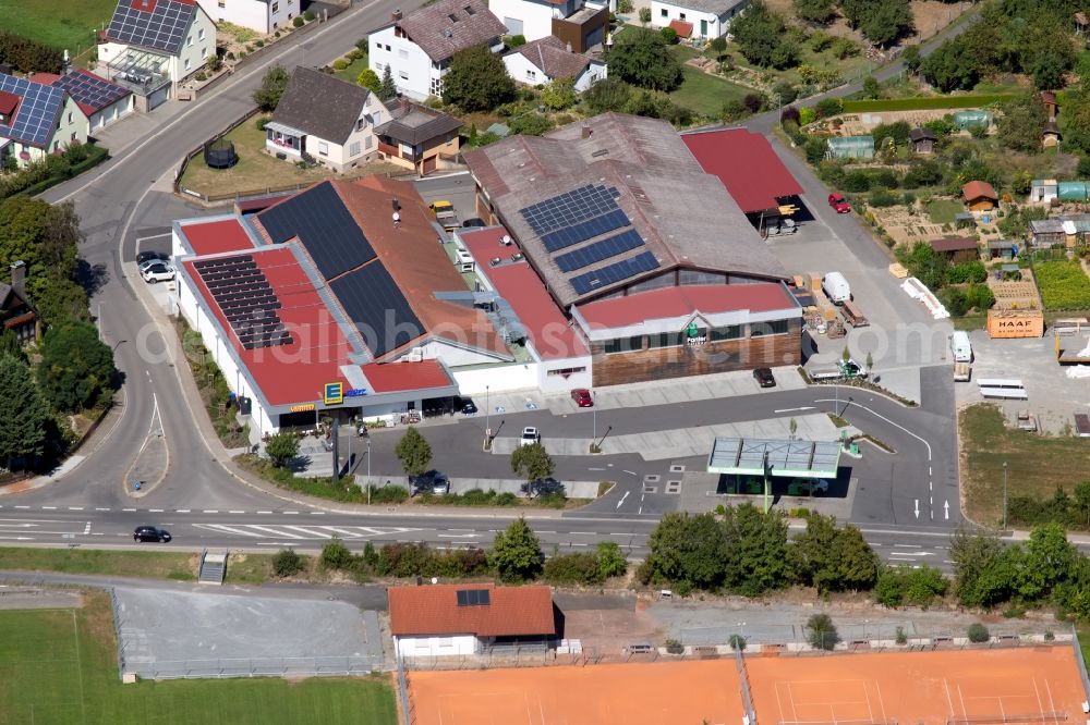 Aerial image Grünsfeld - Store of the Supermarket Edeka aktiv Duerr and the building of the carpentry Panter Holzbau GmbH at the Gartenweg in Gruensfeld in the state Baden-Wurttemberg, Germany