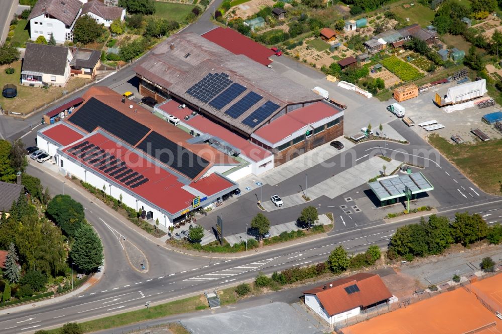 Aerial photograph Grünsfeld - Store of the Supermarket Edeka aktiv Duerr and the building of the carpentry Panter Holzbau GmbH at the Gartenweg in Gruensfeld in the state Baden-Wurttemberg, Germany