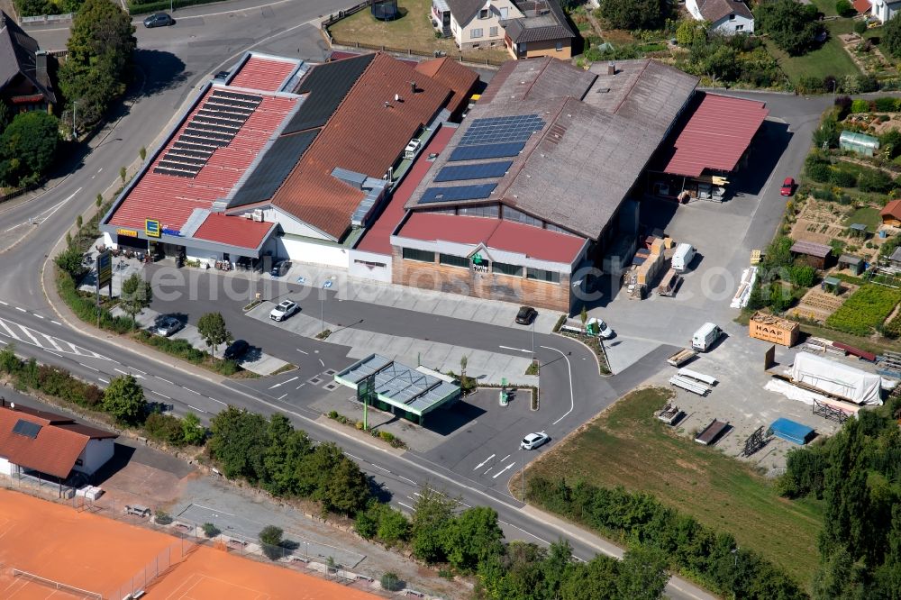 Grünsfeld from above - Store of the Supermarket Edeka aktiv Duerr and the building of the carpentry Panter Holzbau GmbH at the Gartenweg in Gruensfeld in the state Baden-Wurttemberg, Germany