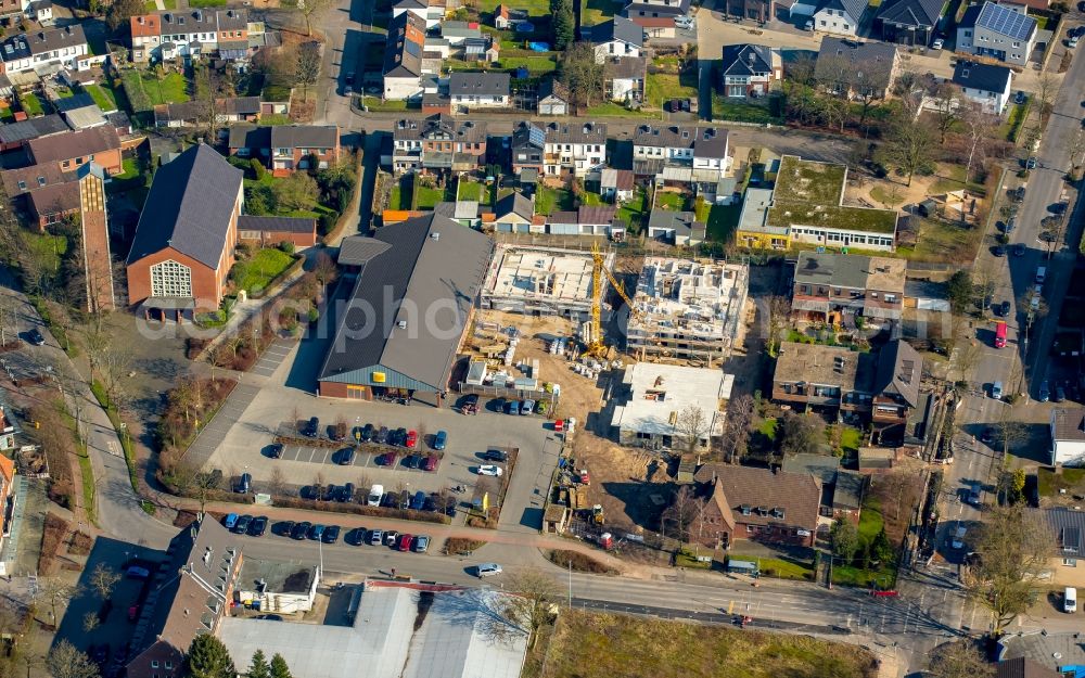 Aerial image Neukirchen-Vluyn - Netto supermarket, St.Quirinus church and construction sites on Max-von-Schenkendorfstrasse in the Neukirchen part of Neukirchen-Vluyn in the state of North Rhine-Westphalia