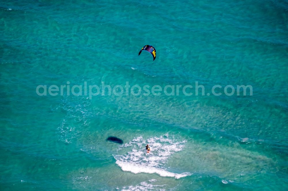 Son Serra de Marina from the bird's eye view: Surfer - kitesurfer in motion in the bay of Alcudia in Son Serra de Marina in Balearic island of Mallorca, Spain