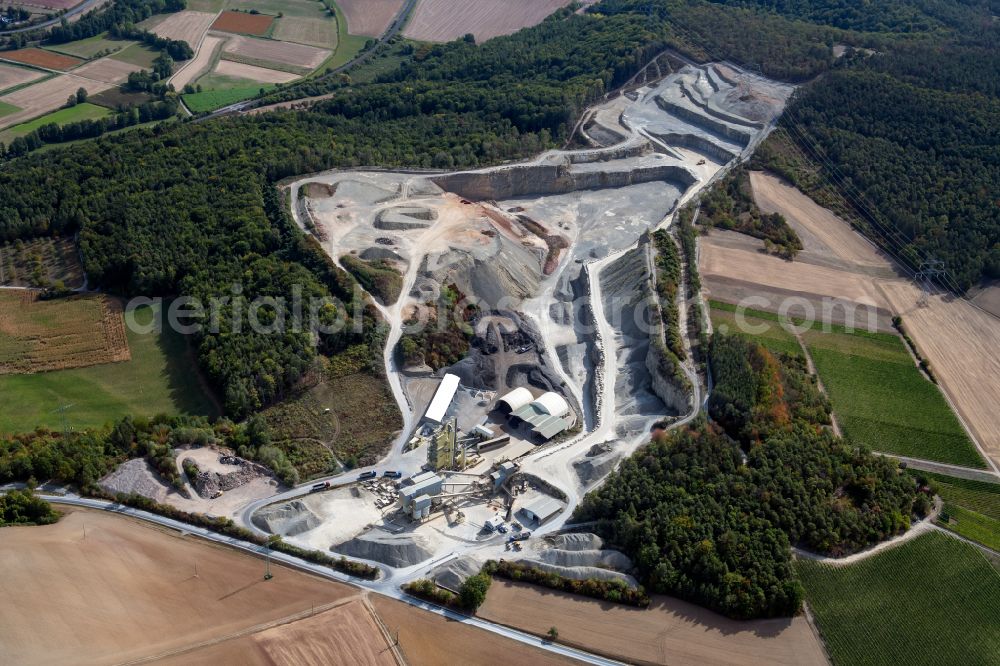 Aerial photograph Gössenheim - Grounds and overburden surfaces open pit mining and building material works of the companies Kalkstein-Schottertwerk Goessenheim GmbH & Co. KG and AMS Asphaltmischwerke Main-Saale GmbH + Co. KG in Goessenheim in the state Bavaria, Germany